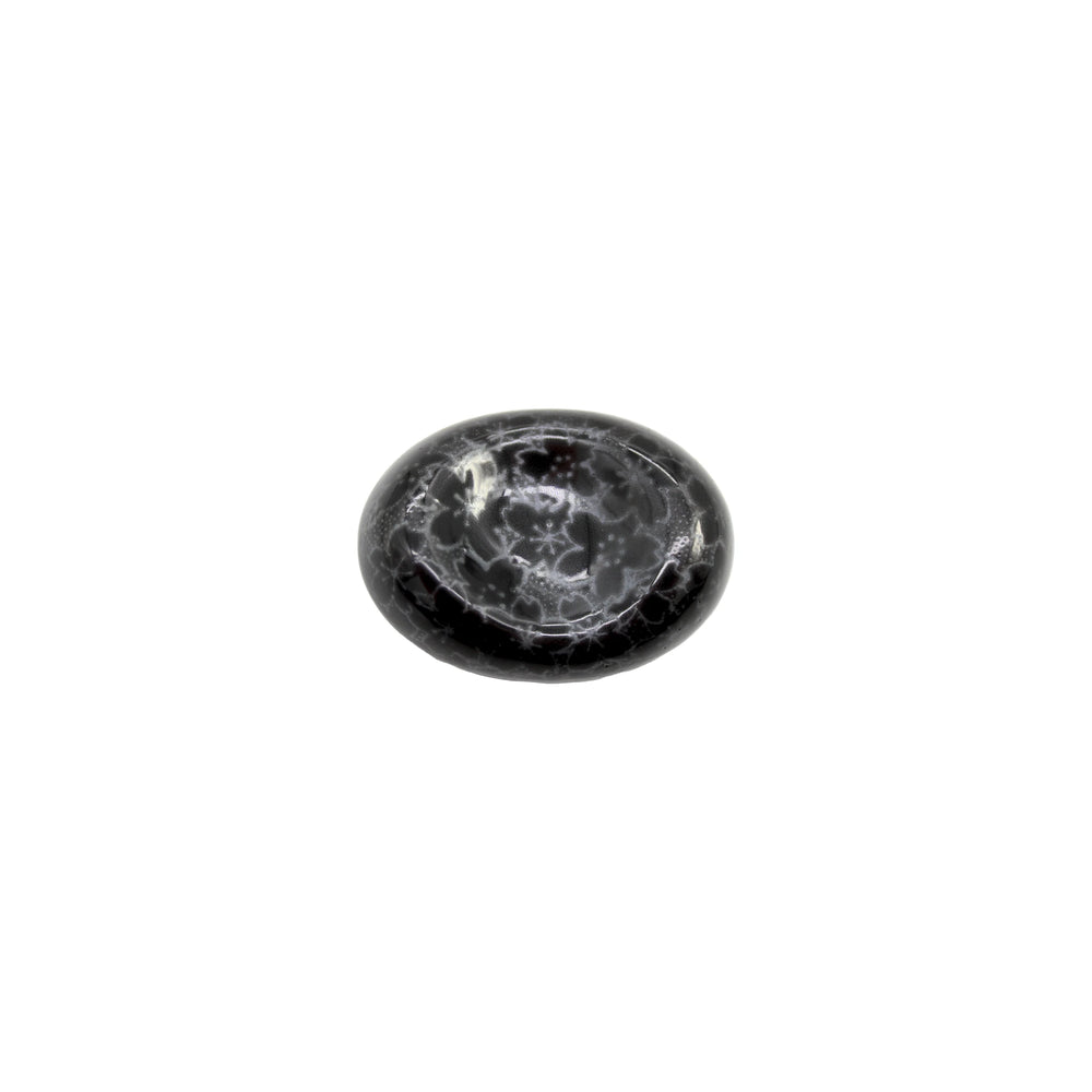 The Chopstick Rest - Pebble Black Sakura features a polished, oval-shaped black surface with a white sakura-like web pattern, inspired by Minoyaki porcelain and displayed on a white background.