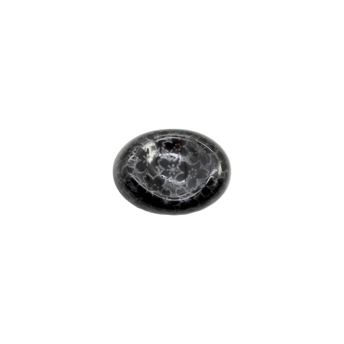 The Chopstick Rest - Pebble Black Sakura features a polished, oval-shaped black surface with a white sakura-like web pattern, inspired by Minoyaki porcelain and displayed on a white background.