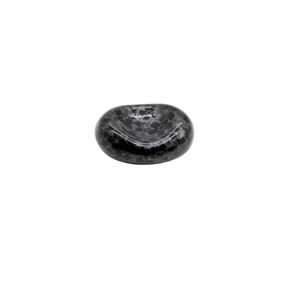 The Chopstick Rest - Pebble Black Sakura is a small, round Minoyaki porcelain piece featuring a smooth, glossy finish and subtle sakura design, shown isolated on a white background.