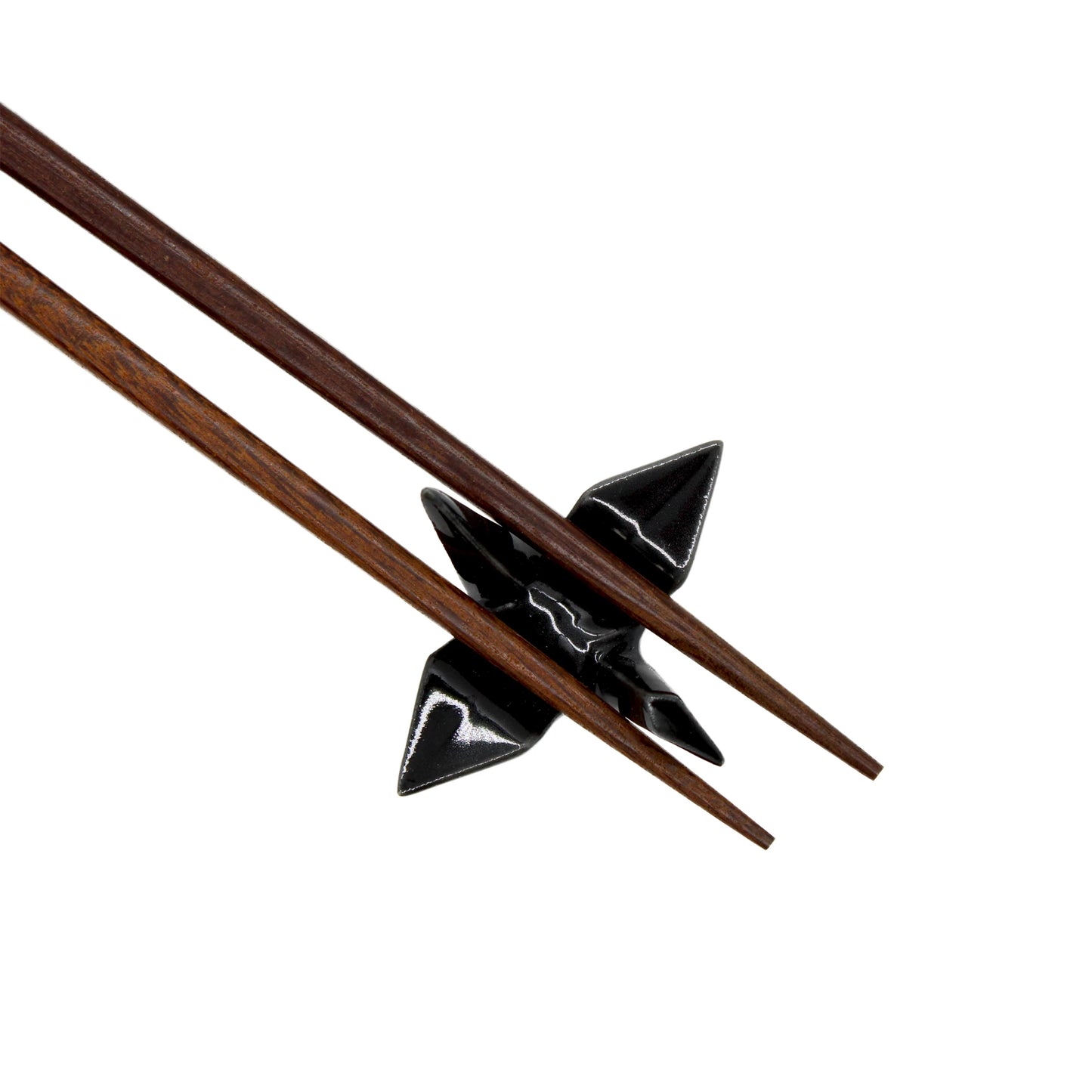 
                  
                    Two wooden chopsticks rest on a black ceramic chopstick rest shaped like an origami crane, inspired by Japanese culture, against a white background. Product: Chopstick Rest - Origami Crane Black.
                  
                