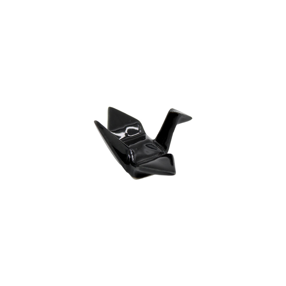 The Chopstick Rest - Origami Crane Black features a small, glossy black ceramic crane design, capturing the elegance of Japanese culture against a plain white background.