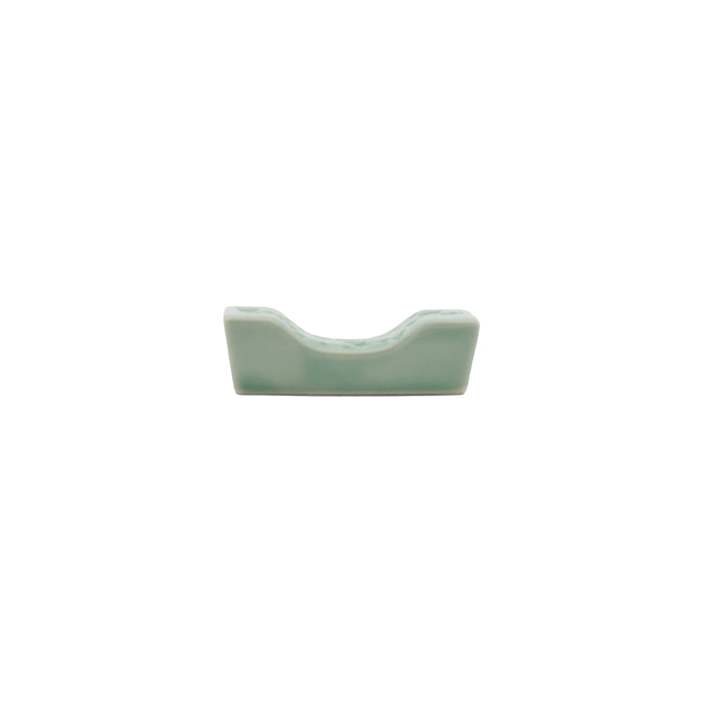 
                  
                    A small, rectangular Chopstick Rest - Sakura Pattern in Celadon Green with a curved center indentation, shown on a plain white background.
                  
                