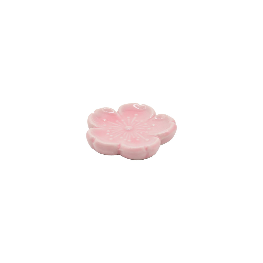 The Chopstick Rest - Pink Sakura, crafted from Minoyaki porcelain and shaped like a cherry blossom flower, adds an elegant touch to Japanese tableware.