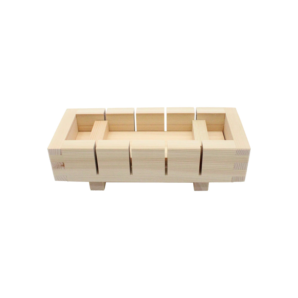 The Cypress Hinoki Oshizushi Press is a rectangular wooden tool with square and rectangular cutouts, set on four short legs, used for making pressed sushi (Oshizushi), shown against a white background.