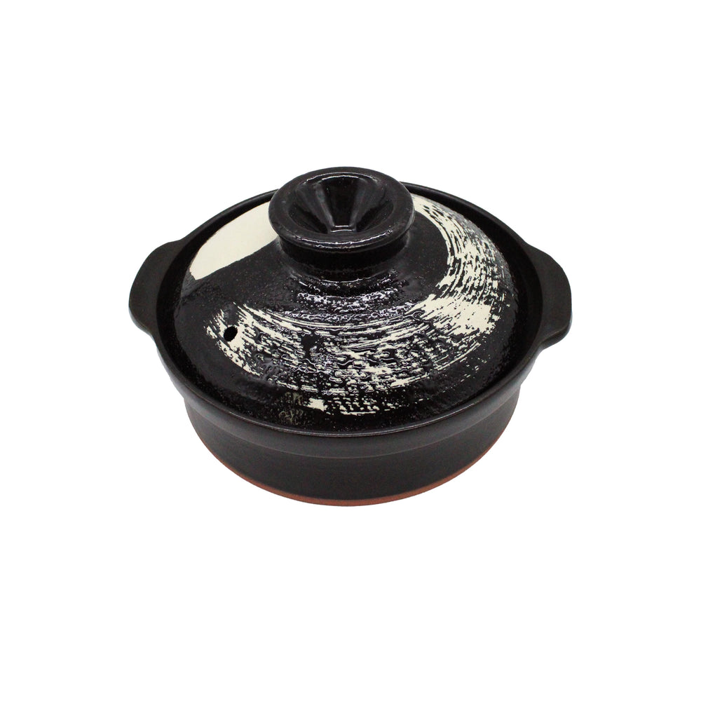 
                  
                    The Black Earthenware Donabe Pot with White Brushstroke Design is shown with its lid against a plain white background.
                  
                