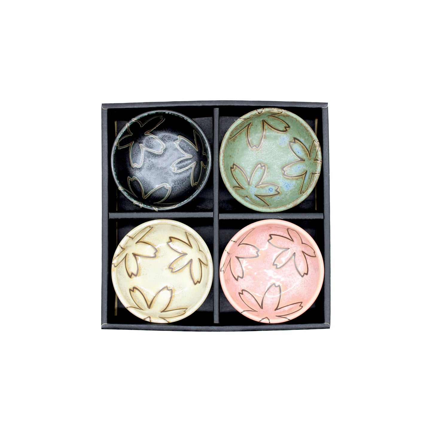 The Flower Design Sauce Dish - Set of 4 features Japanese ceramic dishes in black, green, cream, and pink with sakura designs, all elegantly packaged in a square divided black box—ideal as a stylish gift set.