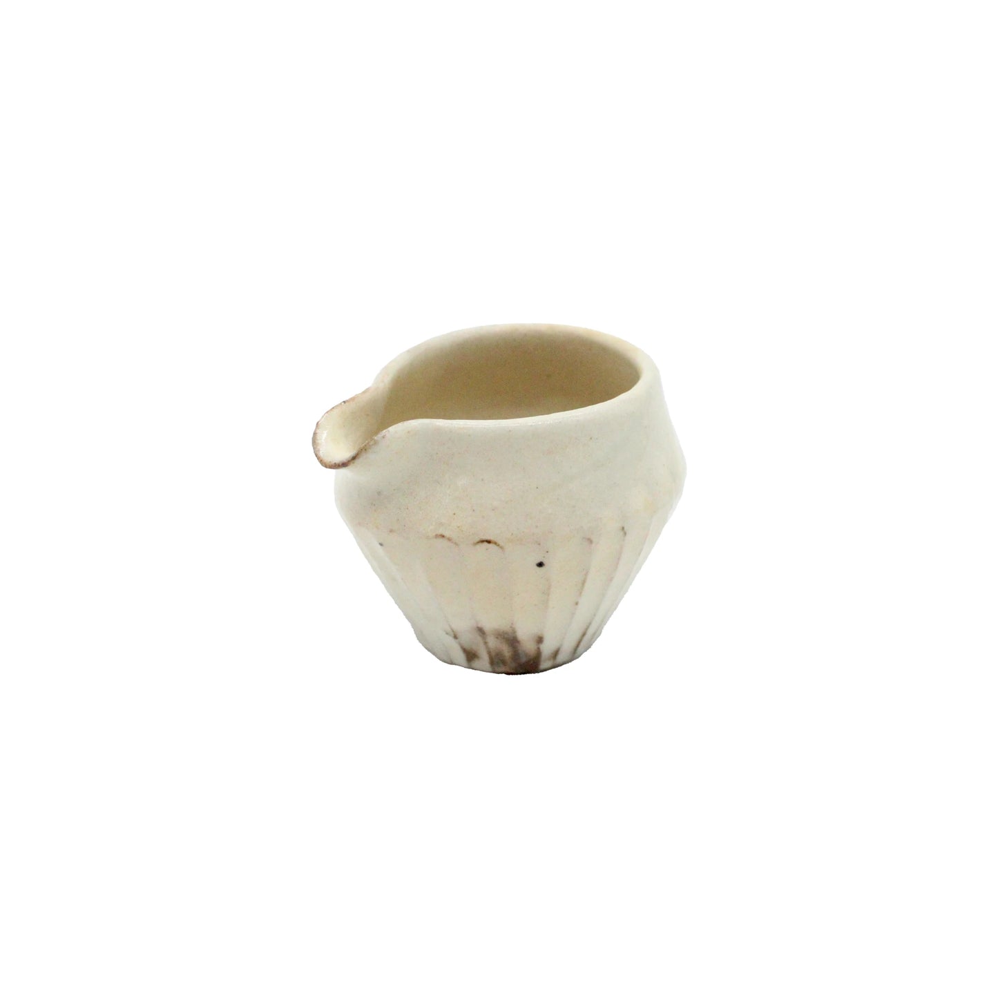 The Pourer - Iron Scatter is a small, off-white Japanese vessel featuring a spout and ribbed base, crafted in the Shigaraki pottery style and displayed against a plain white background.