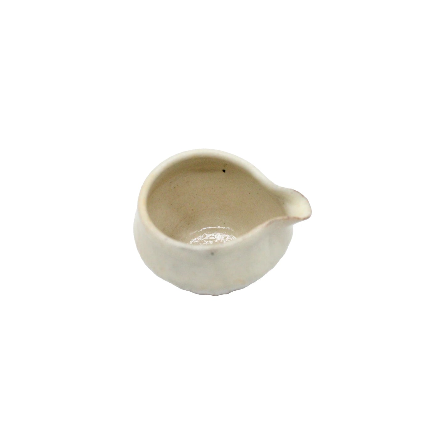 Small, round, off-white ceramic bowl with a spout— the Pourer - Iron Scatter— inspired by Japanese pourer designs and crafted in Shigaraki pottery style, shown on a plain white background.