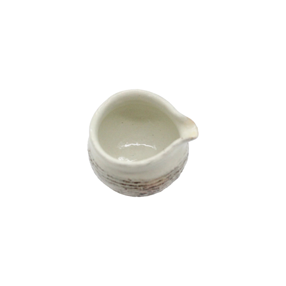 The Fuchiara Carved Pourer is a white ceramic Japanese pourer with a spout, crafted in the Shigaraki pottery style and shown from above against a plain white background.