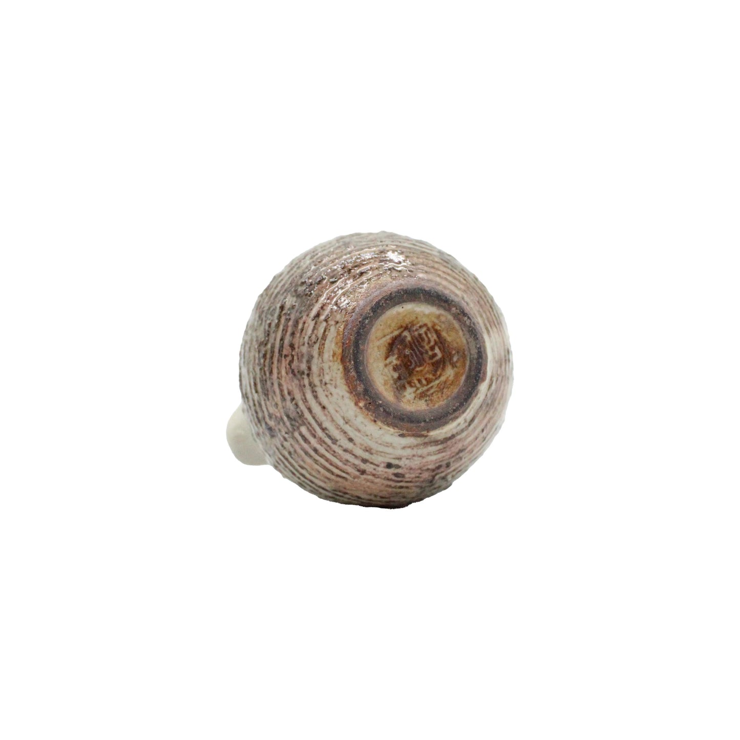 
                  
                    The Pourer - Fuchiara Carved features a round, spiral design in earthy tones inspired by Shigaraki pottery, showcased against a plain white background.
                  
                