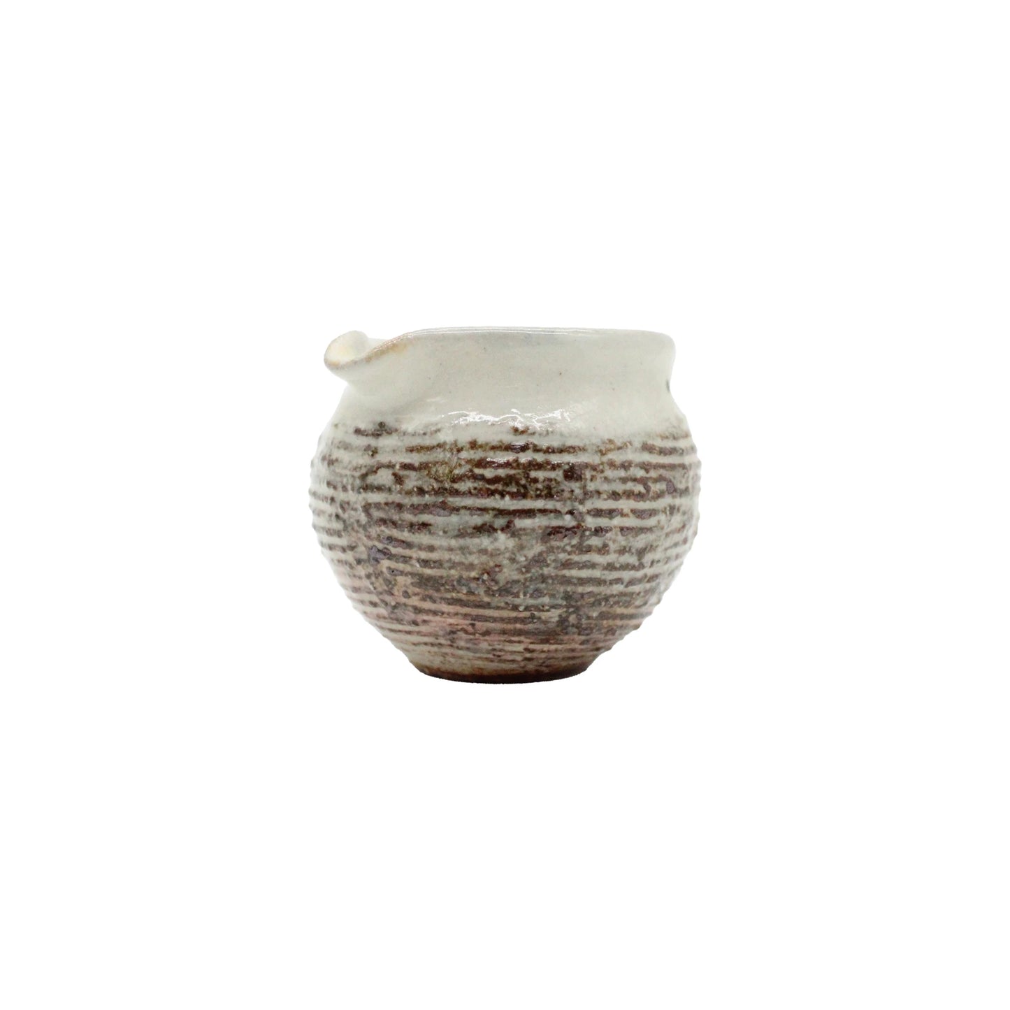 
                  
                    The Pourer - Fuchiara Carved is a small, round Japanese pourer made from textured ceramic with a narrow opening and spout. It features a white, slightly uneven glaze with horizontal ridges inspired by Shigaraki pottery artistry.
                  
                