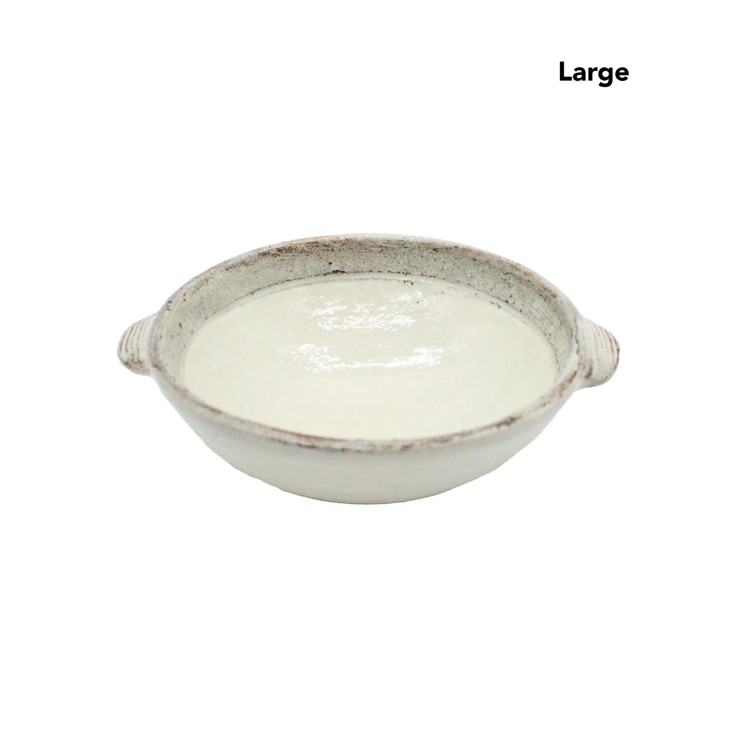 
                  
                    A large, round, shallow ceramic dish called the Ear Bowls - Fuchiara Carved, with two small handles and a refined Kohiki finish, contains a white liquid.
                  
                