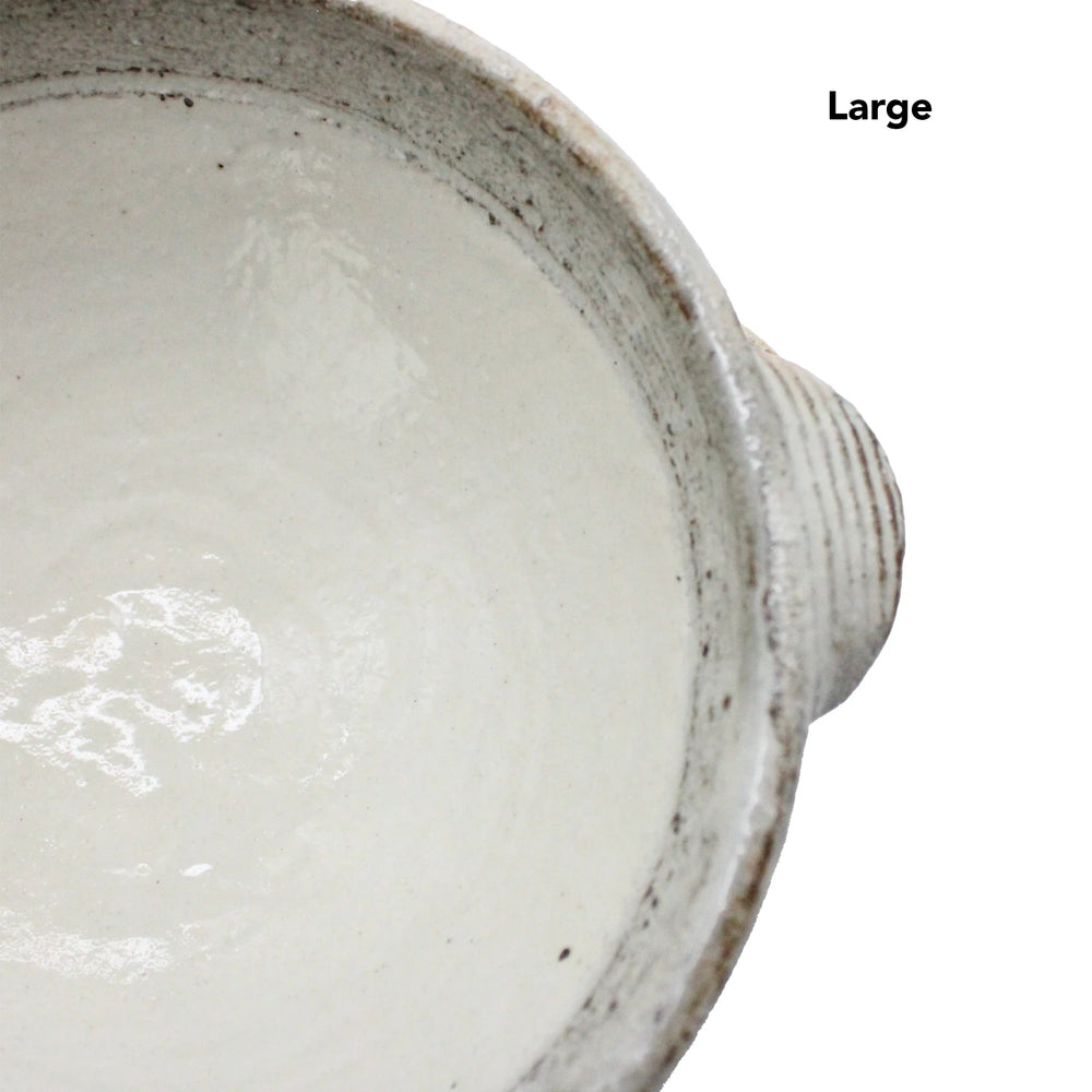 
                  
                    Top view of the Ear Bowls - Fuchiara Carved, a large white ceramic bowl with a right-side handle, inspired by Japanese ceramics with a Kohiki finish. Large is printed in black text on the bowls white surface.
                  
                