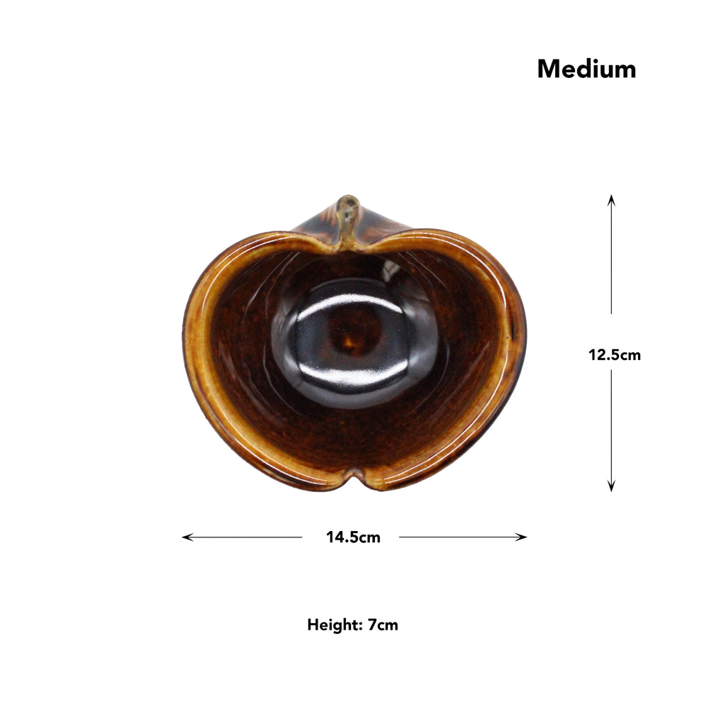 
                  
                    Top view of the Apple Bowls - Candy Glaze, a brown ceramic vessel with heart-shaped opening, inspired by Japanese pottery and labeled Medium. Dimensions: 14.5 cm wide, 12.5 cm high, 7 cm deep.
                  
                