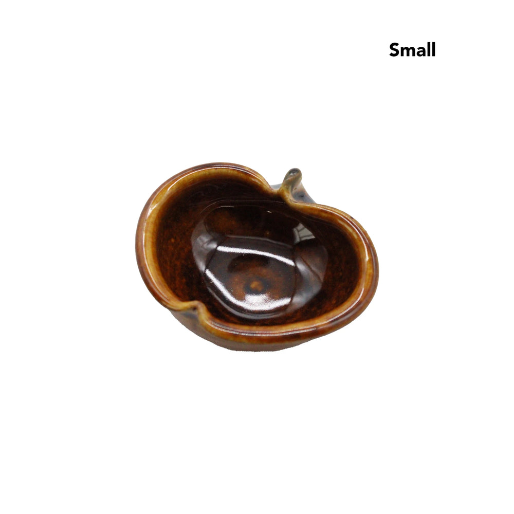 
                  
                    An Apple Bowls - Candy Glaze, small and brown with a glossy finish, is shown from above on a plain white background. The kidney-shaped ceramic bowl reflects Japanese pottery style, with Small in the top right corner.
                  
                