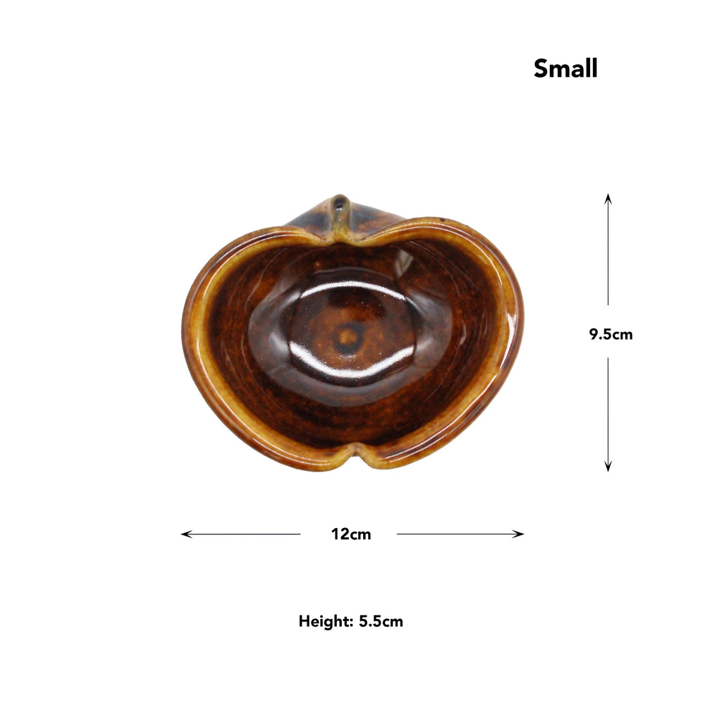 
                  
                    Top view of a small, brown Apple Bowls - Candy Glaze piece inspired by Japanese pottery; heart-shaped and measuring 12cm wide, 9.5cm tall, and 5.5cm high.
                  
                