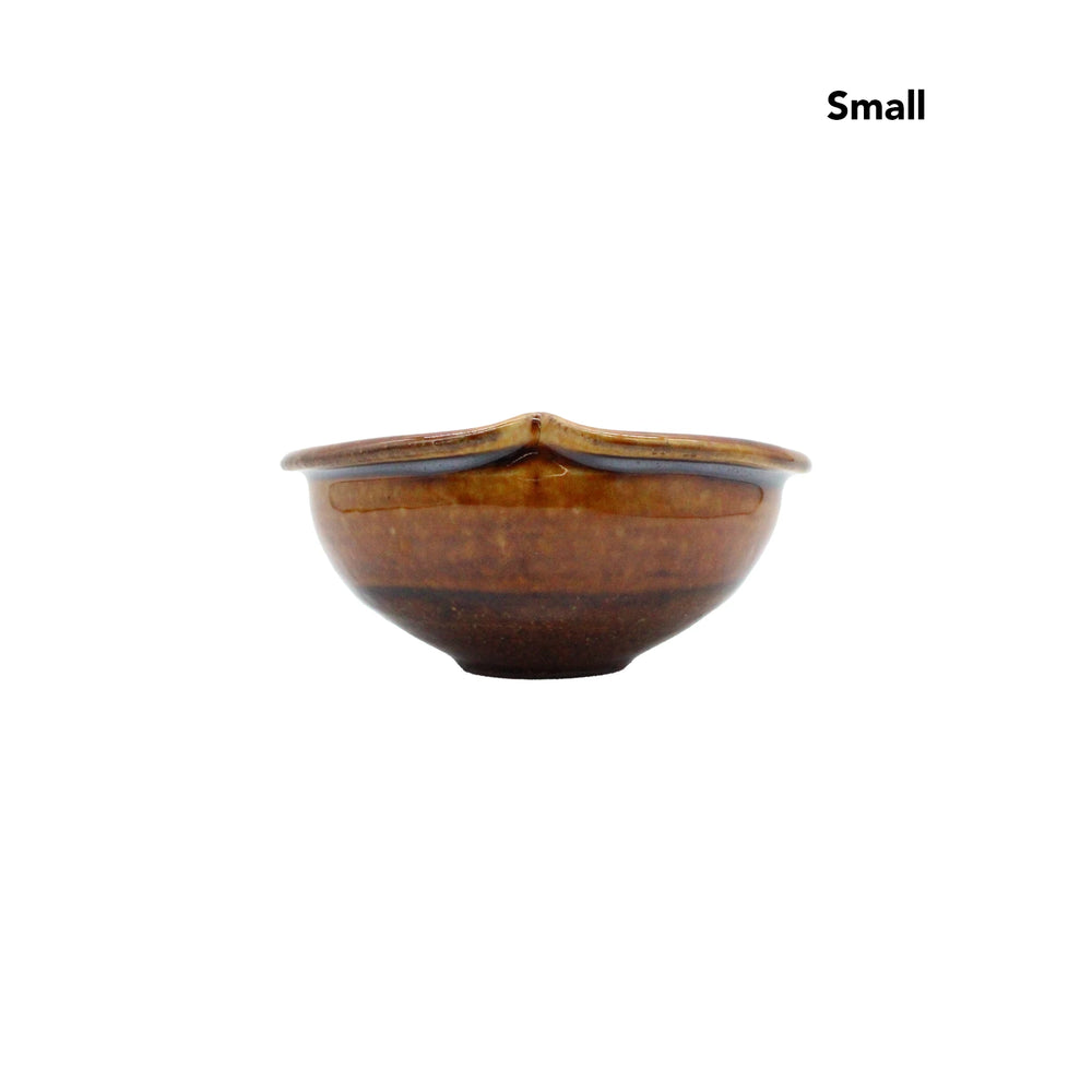 
                  
                    A small, round, brown ceramic bowl from the Apple Bowls - Candy Glaze collection is displayed against a plain white background, with Small shown in the top right corner.
                  
                