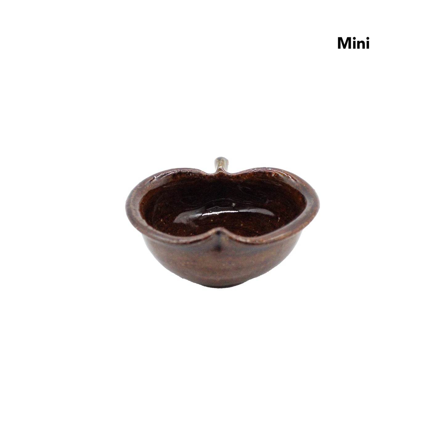 
                  
                    A small, brown, apple-shaped ceramic bowl from the Apple Bowls - Candy Glaze collection, labeled Mini in the top right corner and displayed against a white background.
                  
                