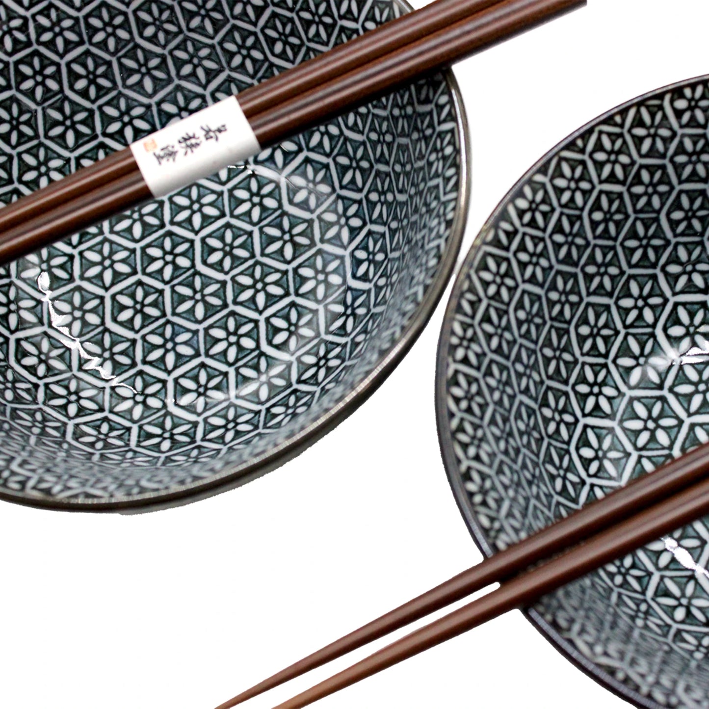 The Asanoha Flower Patterned Bowls Boxed Set - Deep Blue includes two Minoyaki porcelain bowls with an elegant Asanoha design, each paired with brown chopsticks resting on the rim.