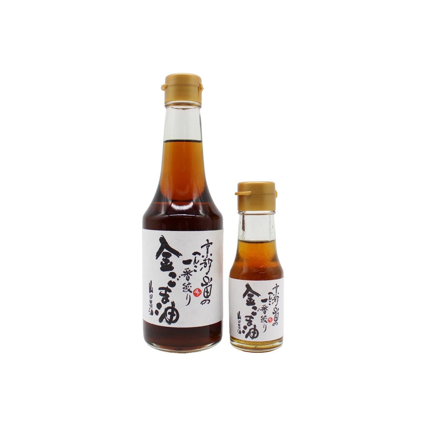 Two bottles of Gold Sesame Oil with gold caps and white labels featuring Japanese text are placed side by side on a white background, showcasing their authentic wood fired roasted flavor.