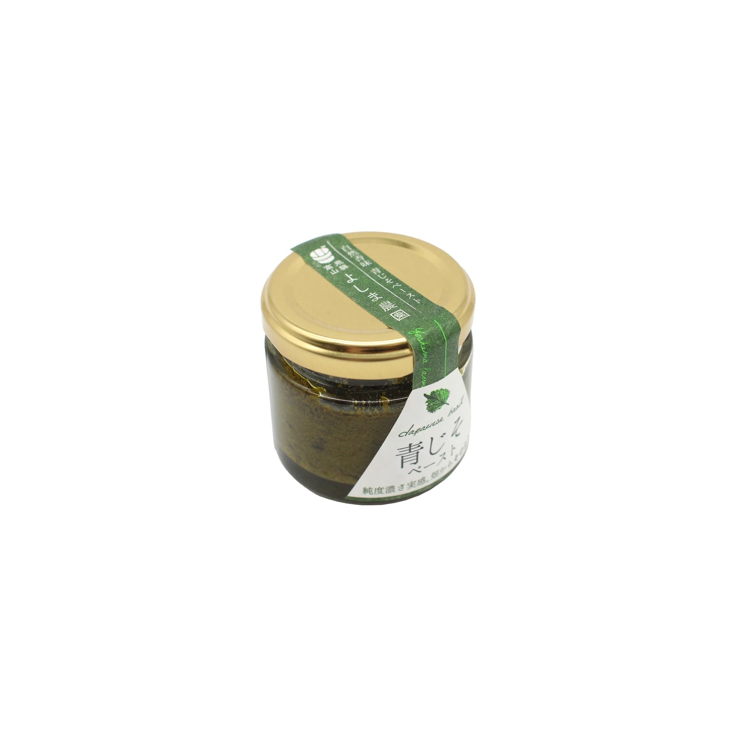 A 50g glass jar of Green Shiso Paste, topped with a gold lid, contains a dark green paste made from green shiso. The jar features a white label and is accented with a green ribbon displaying Japanese text.