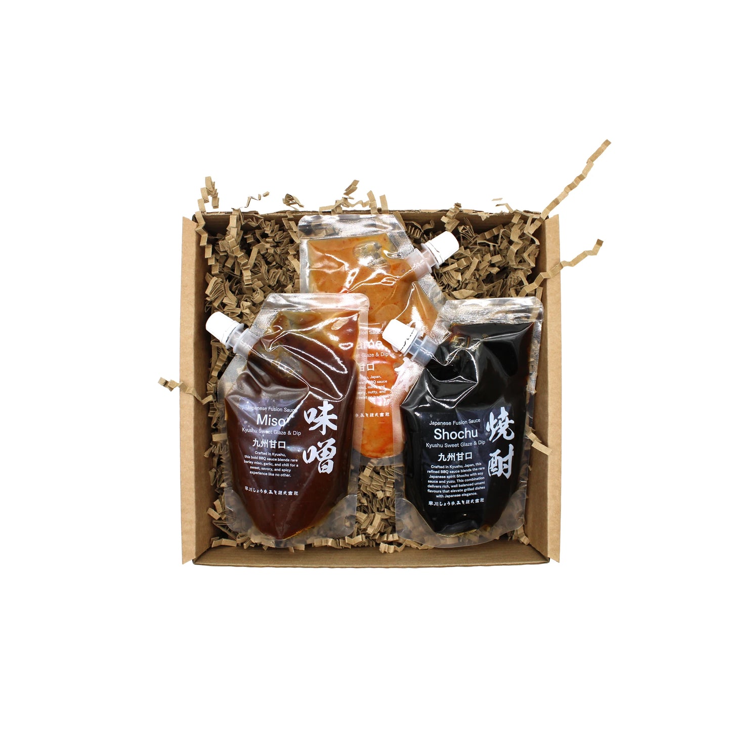 
                  
                    Three stand-up pouches labeled Miso, Shochu, and another sauce in a cardboard box with brown paper filler—Hayakawa BBQ Sauce Set is perfect for exploring Japanese flavors or making your own miso BBQ sauce.
                  
                