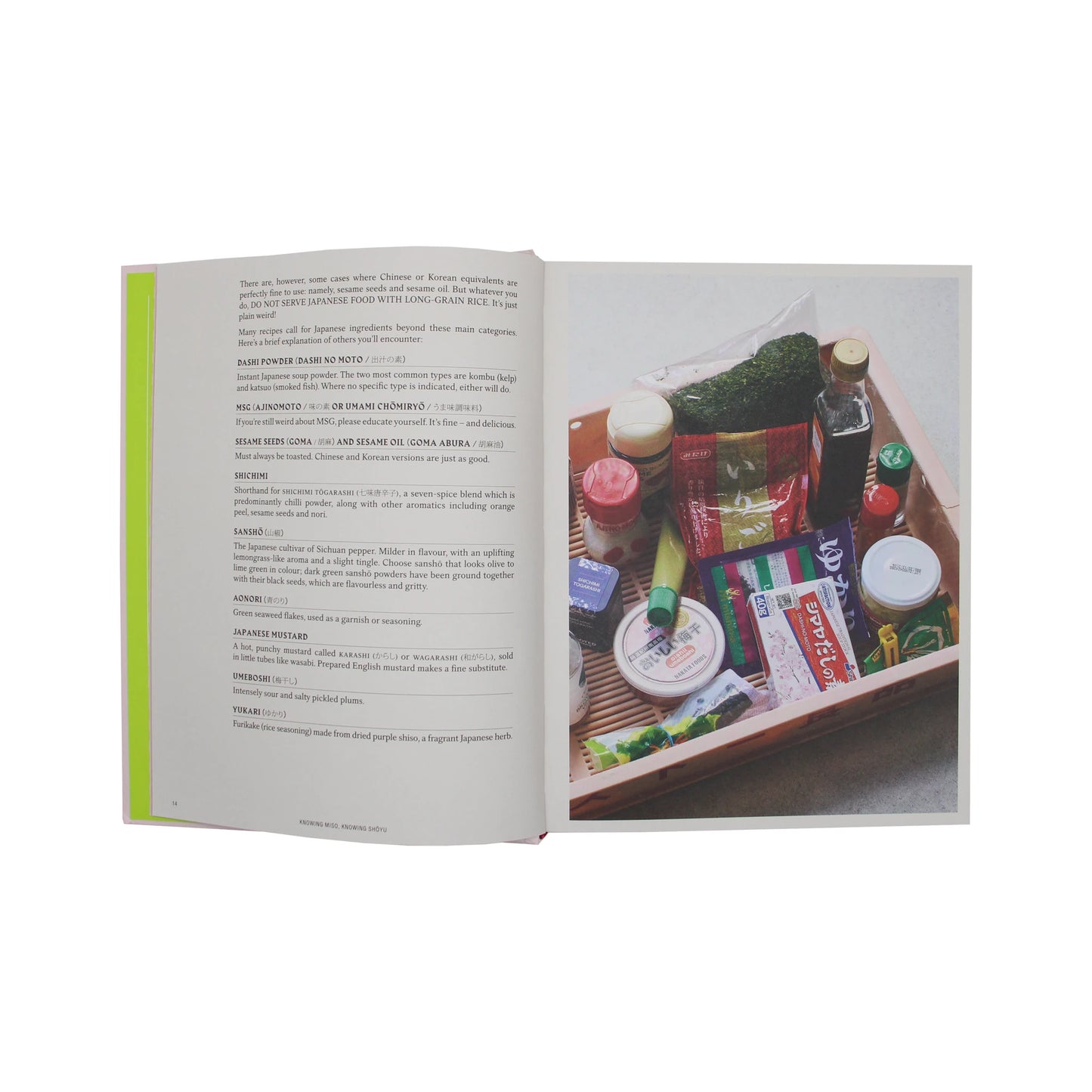 An open copy of Japaneasy Kitchen by Tim Anderson showing a page of Japanese pantry ingredients next to a wooden crate filled with various food items and condiments.