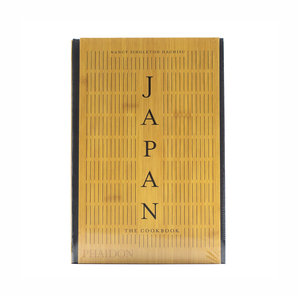 The front cover of Japan – The Cookbook by Nancy Singleton Hachisu, with vertical black text on a bamboo-patterned background, echoes the refined style of traditional Japanese cuisine.