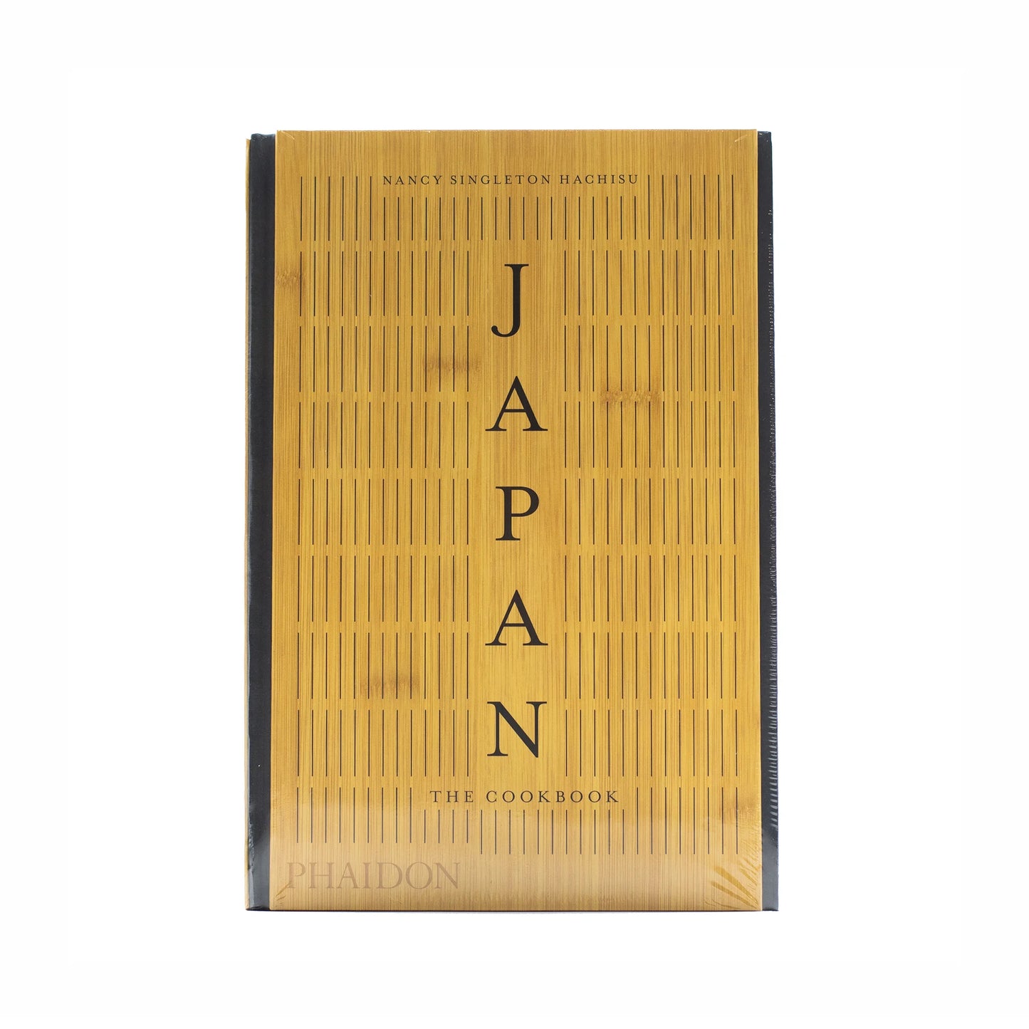 The front cover of Japan – The Cookbook by Nancy Singleton Hachisu, with vertical black text on a bamboo-patterned background, echoes the refined style of traditional Japanese cuisine.