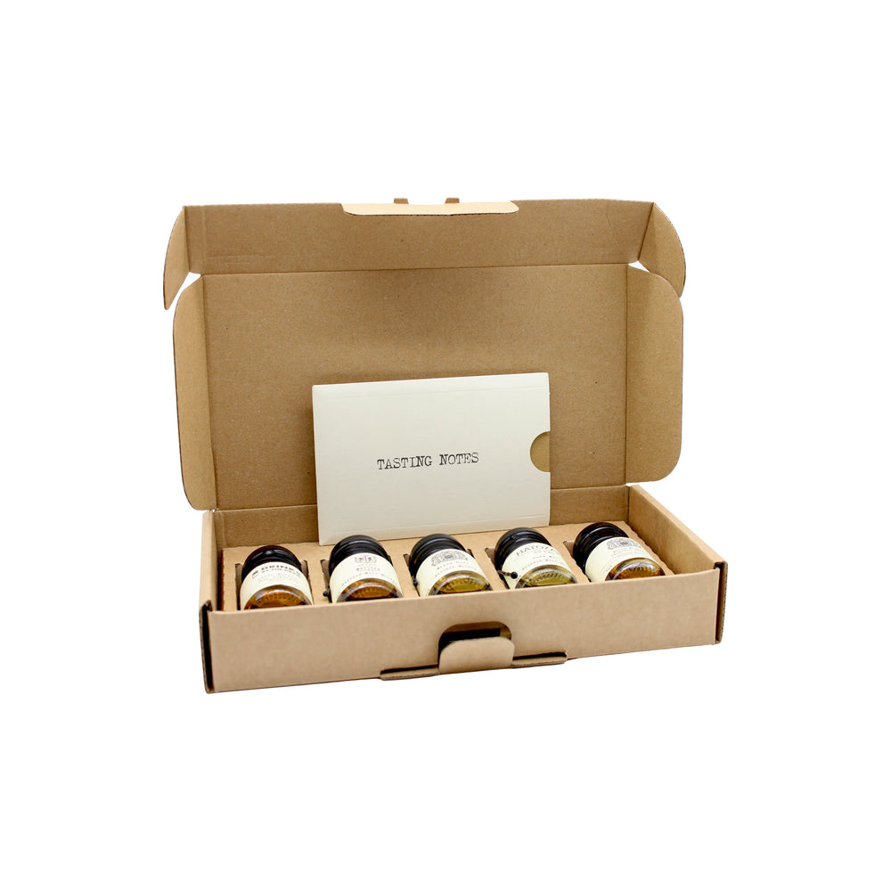 
                  
                    The Japanese Whisky Tasting Set features five labeled mini jars and a Tasting Notes card, all neatly packed in a cardboard box—an ideal introduction to whisky styles, shown against a white background.
                  
                