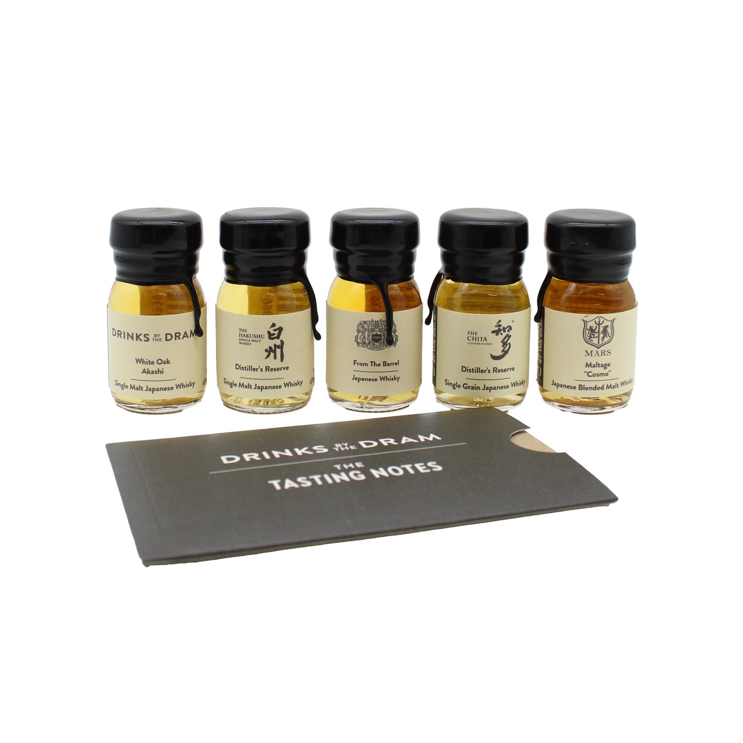 
                  
                    Five small bottles from The Japanese Whisky Discovery Tasting Set are lined up behind a black card labeled DRINKS by the DRAM THE TASTING NOTES, inviting you to an authentic whisky tasting experience.
                  
                
