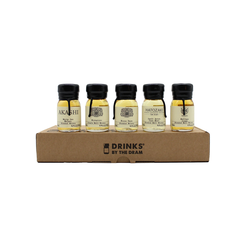 Five small bottles from the Japanese Whisky Tasting Set are displayed on a cardboard tray labeled Drinks by the Dram, offering a unique whisky tasting experience against a plain white background.