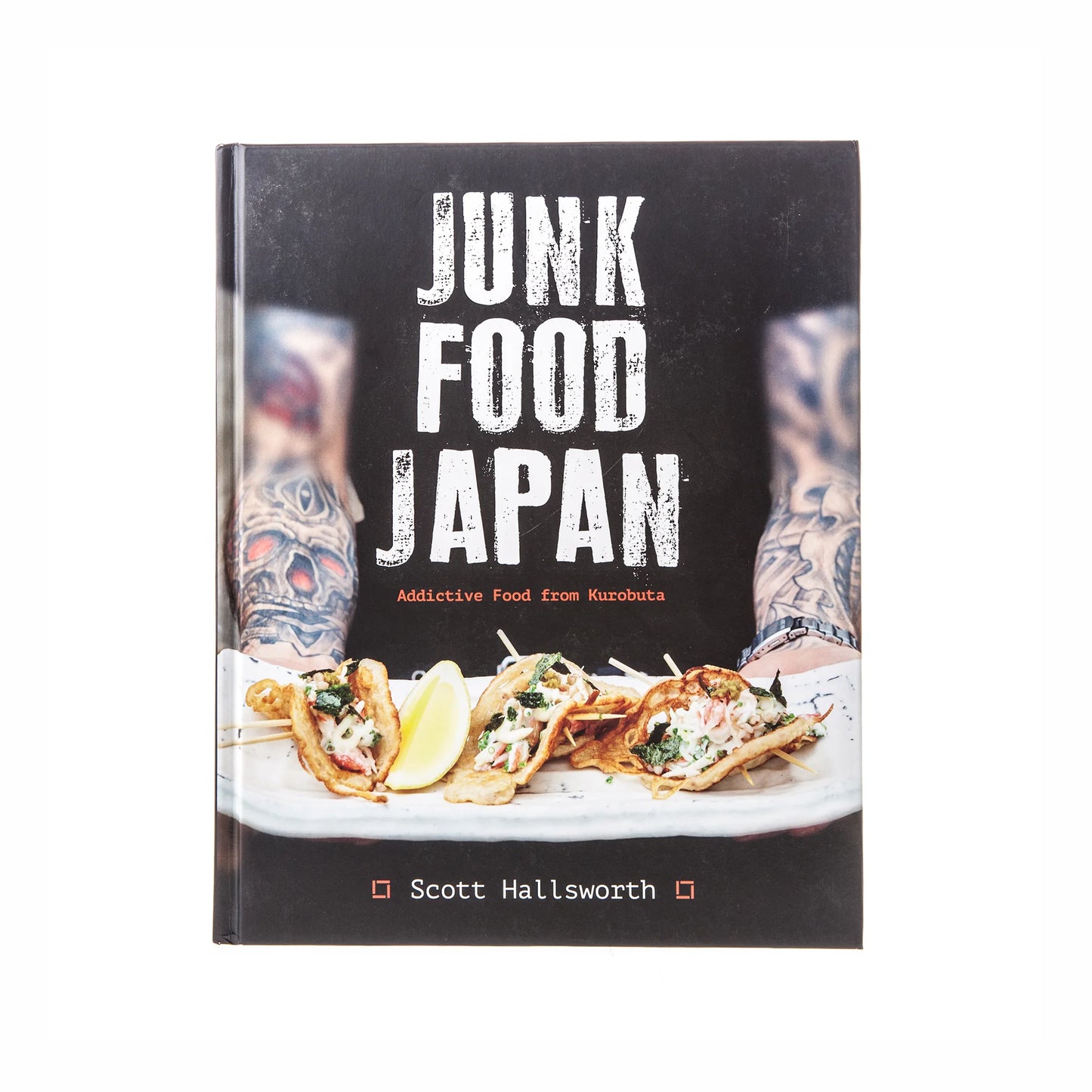 The cover of Junk Food Japan by Scott Hallsworth showcases inventive Japanese comfort food recipes, with tattooed arms visible in the background.
