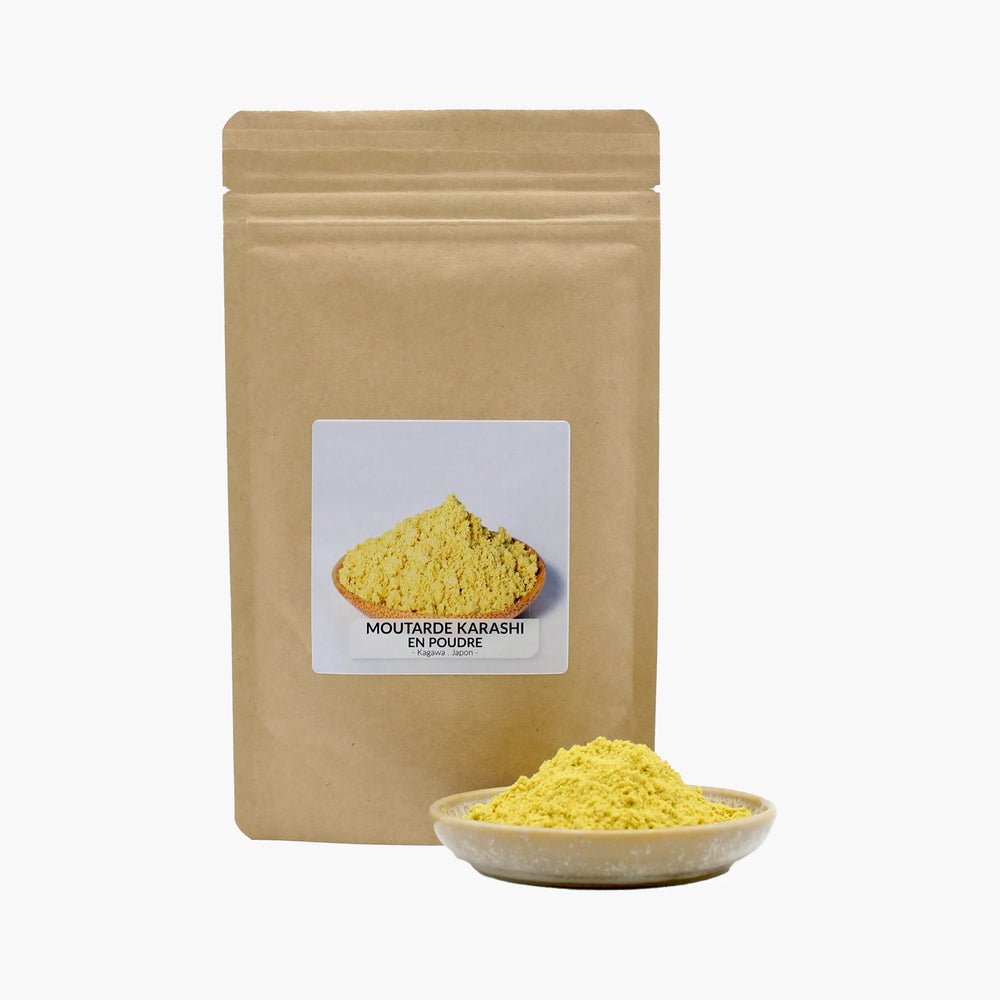 A brown resealable pouch labeled Karashi Mustard Powder - 50g stands behind a small dish filled with vibrant yellow Japanese mustard powder, highlighting the bold flavors of traditional Karashi mustard.
