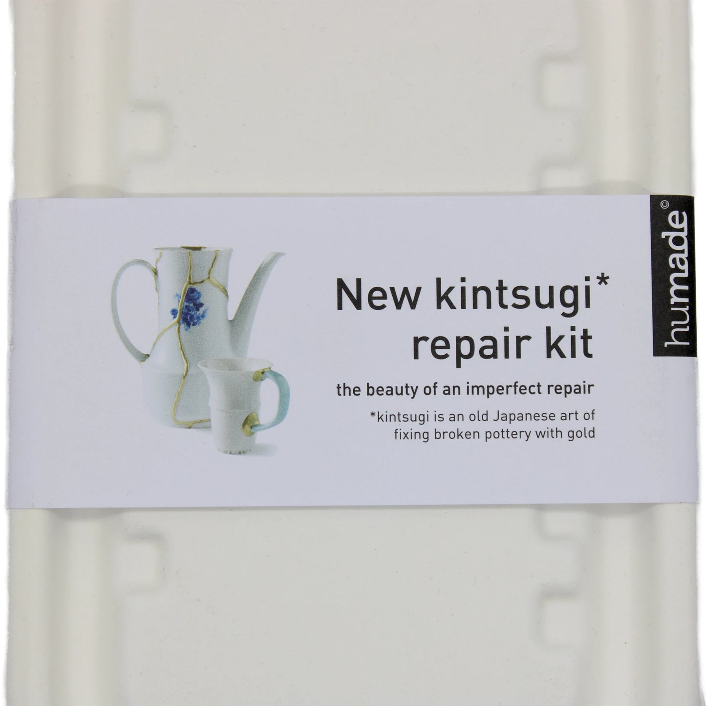 
                  
                    A white box labeled Kintsugi Kits - Gold, Silver & Bronze displays two porcelain pieces with metallic accents and includes a brief note on the Japanese art of mending pottery with gold.
                  
                