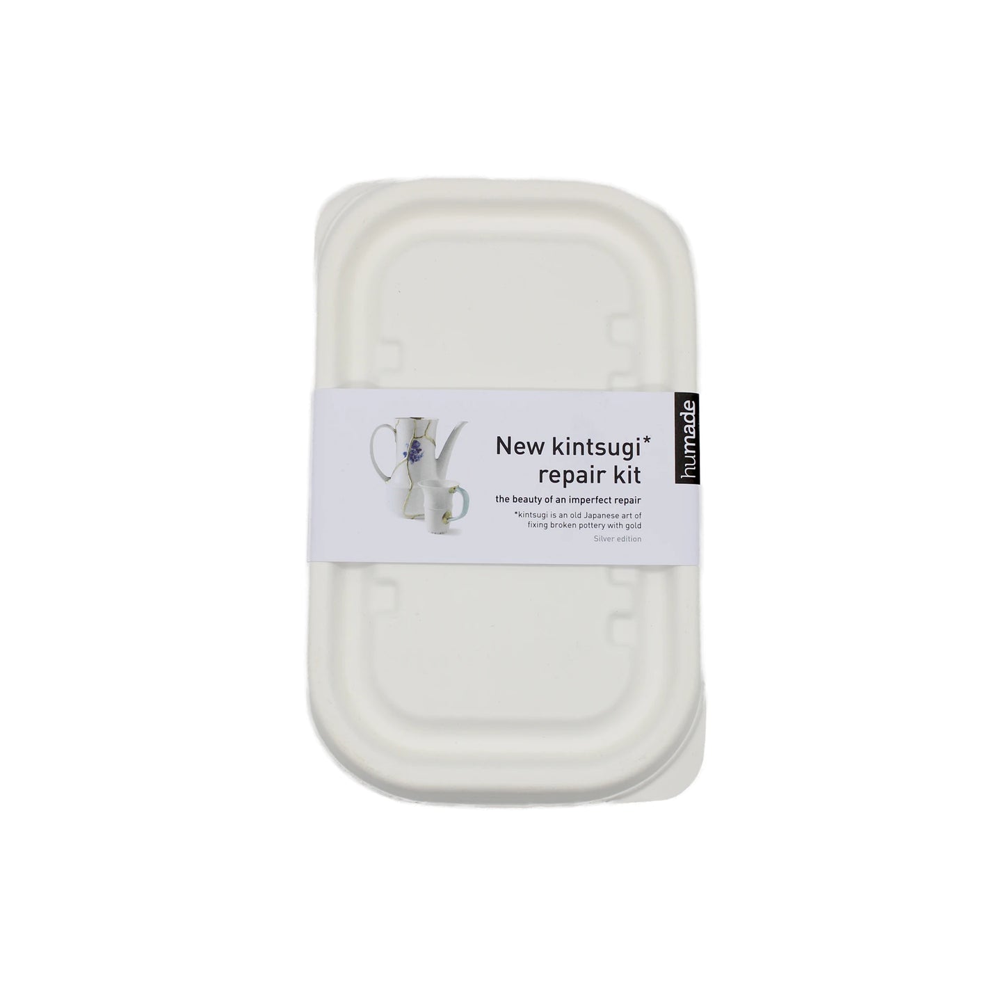
                  
                    A white rectangular Kintsugi Kits - Gold, Silver & Bronze container features a label with a ceramic object mended in metallic finish and product information.
                  
                