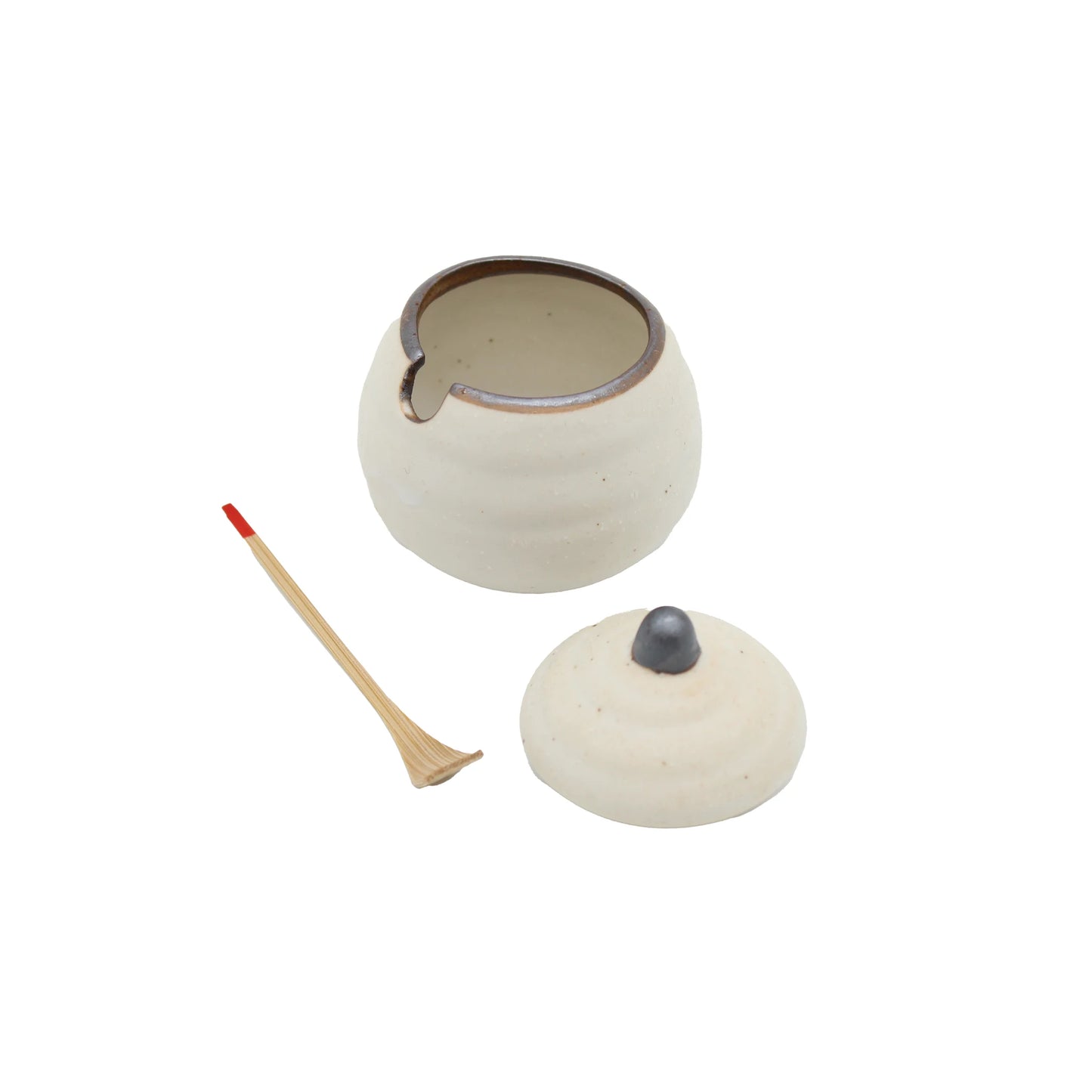 
                  
                    The Karashi / Shichimi Spice Pot - White Kohiki is a small ceramic pot with a removable lid, a slot for a stick, and comes with a bamboo matchstick featuring a red tip, shown on a white background.
                  
                