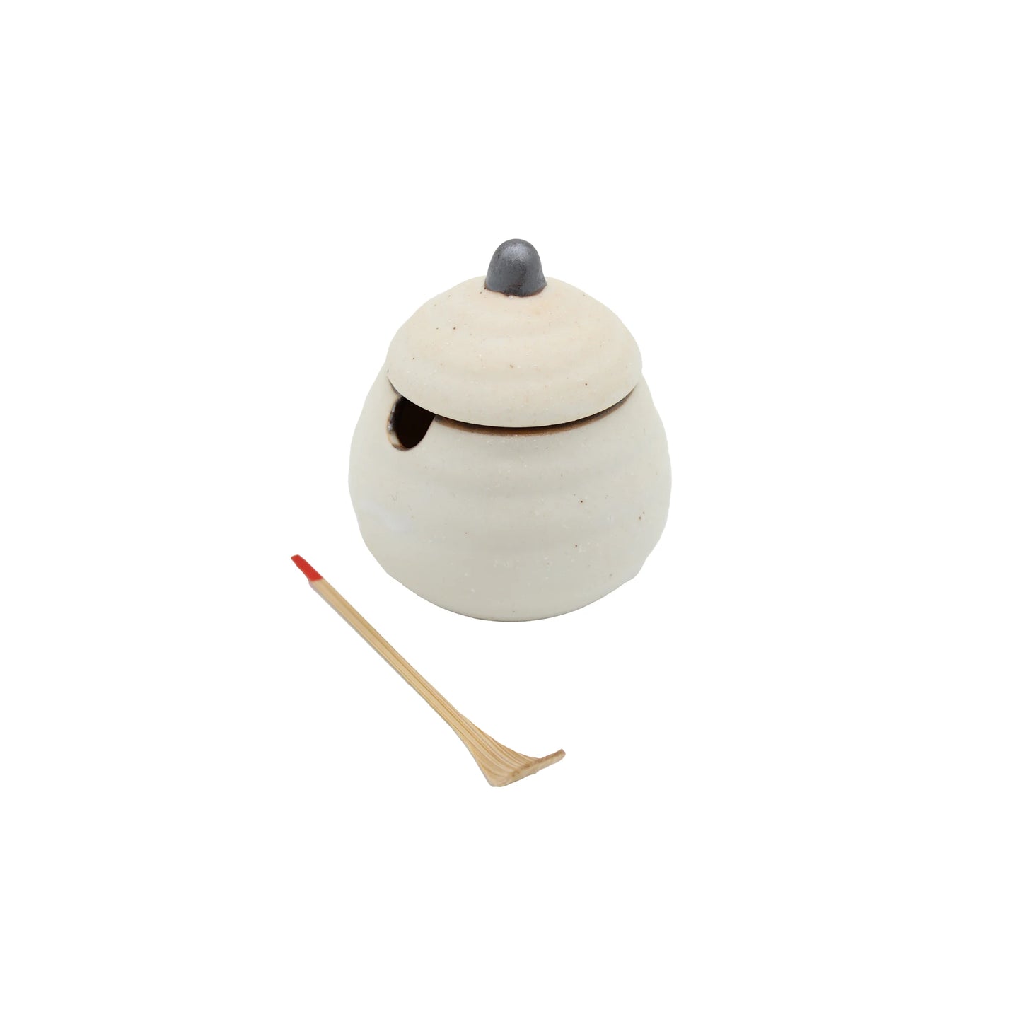 The Karashi / Shichimi Spice Pot - White Kohiki is a small Japanese pottery pot with a lid and notch, paired with a wooden spoon featuring a pointed red tip, shown on a white background.