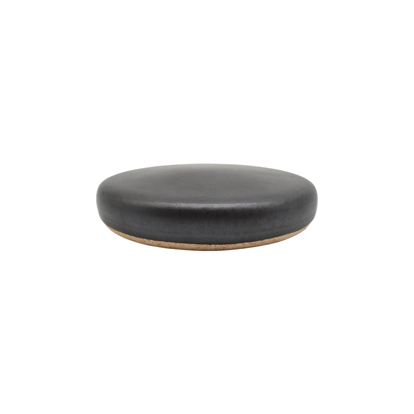 
                  
                    The Ishiyaki - Grilling Stone is a round, flat, black ceramic coaster with a cork base, inspired by Japanese volcanic cooking stones, shown against a white background.
                  
                