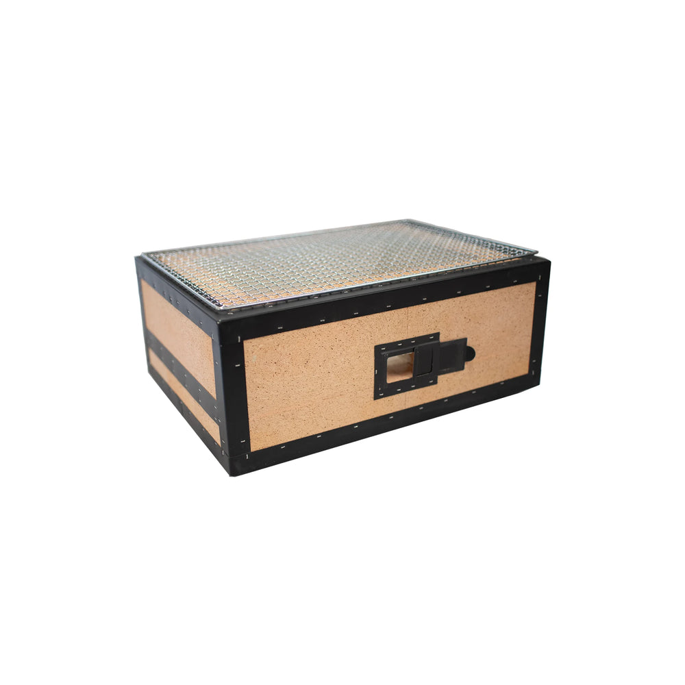 The Konro Grill, Table Barbecue - 47cm features a black frame, tan sides, metal latch, and textured lid—evoking the sturdy style of traditional Japanese charcoal grills—shown isolated against a white background.