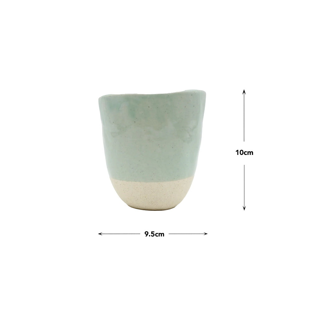 The Lopsided Mug - Tomei Blue is a two-tone ceramic cup with a matte duck egg blue top and off-white earthenware base, measuring 10 cm high and 9.5 cm wide, displayed on a plain white background.