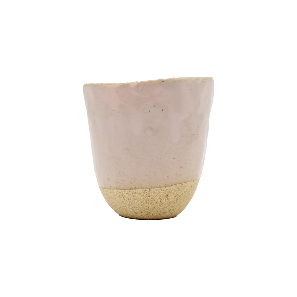 The Lopsided Mug - Pink is a handmade earthenware mug with a biscuit-colored base, an unglazed textured lower half, and a pink glazed upper half—an elegant Marunaka family creation shown on a plain white background.