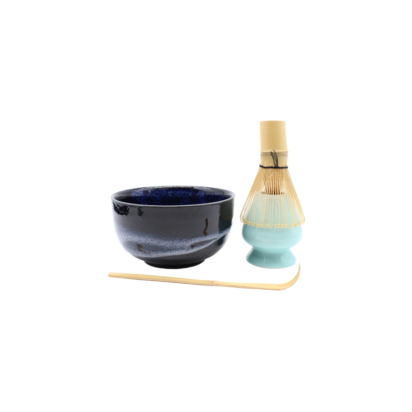 The Matcha Tea Set - Blue features a black and blue ceramic bowl, bamboo whisk on a light green stand, and bamboo spoon—an elegant set inspired by Japanese tea ceremonies, beautifully arranged on a clean white background.