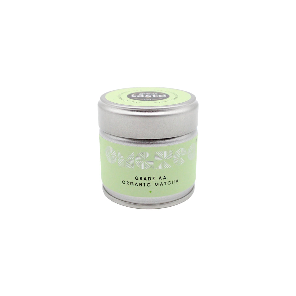 A small silver tin labeled Grade AA Organic Matcha Tea - 30g is centered on a white background, featuring a light green label.