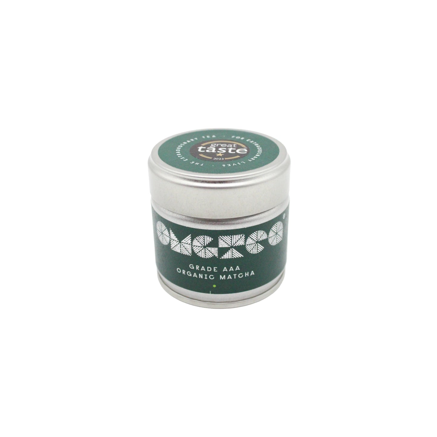 A small silver tin labeled AAA Grade Organic Matcha Green Tea – 30g with a green lid and a decorative white pattern.