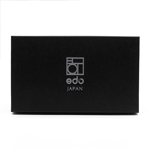 A black rectangular box with edo JAPAN and a geometric logo in white on the front, ideal for storing the Matcha Tea Set - Green, which includes a ceramic bowl and bamboo whisk.