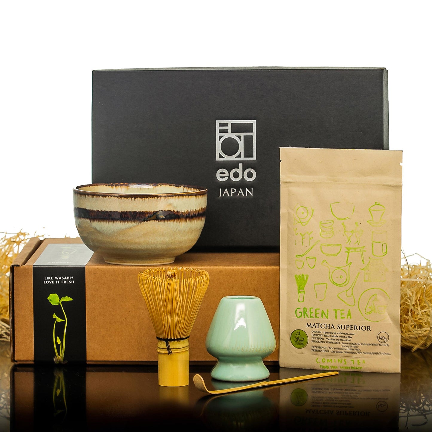 
                  
                    The Matcha Tea Set in Green with Matcha Tea includes a ceramic bowl, bamboo whisk and scoop, premium matcha packet, and two boxes, elegantly displayed on a reflective surface for authentic Japanese tea making.
                  
                