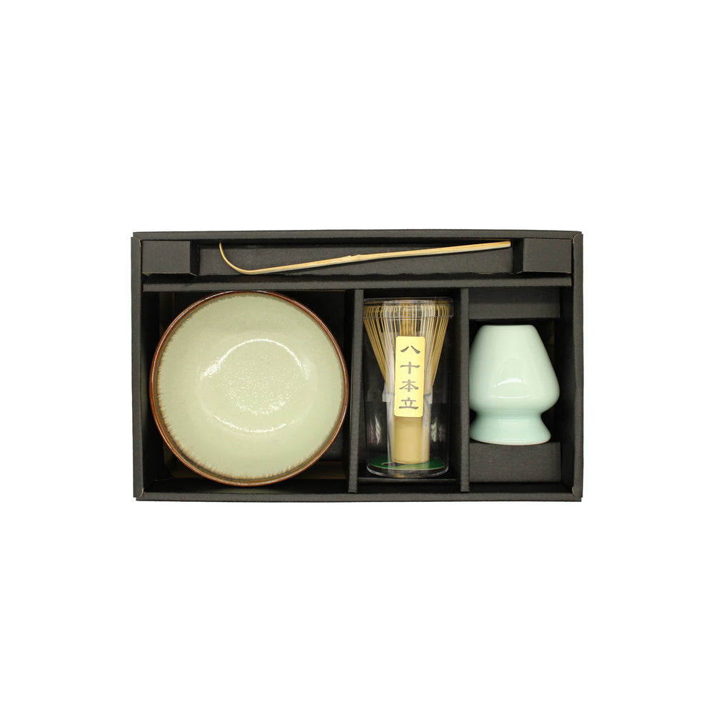 The Matcha Tea Set - Green includes a ceramic bowl, bamboo whisk, bamboo scoop, and a small white cup, each neatly organized in its own compartment within the box.