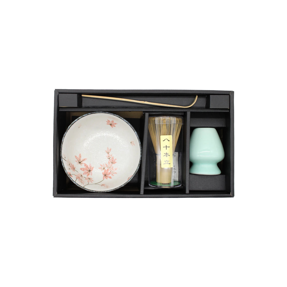 Matcha Tea Set - Maple Leaf includes a boxed set with a maple leaf-patterned bowl, bamboo whisk, metal tea scoop, and green ceramic cup—each piece curated for an authentic Japanese tea ceremony experience.
