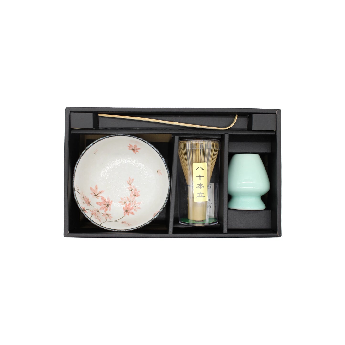 Matcha Tea Set - Maple Leaf includes a boxed set with a maple leaf-patterned bowl, bamboo whisk, metal tea scoop, and green ceramic cup—each piece curated for an authentic Japanese tea ceremony experience.